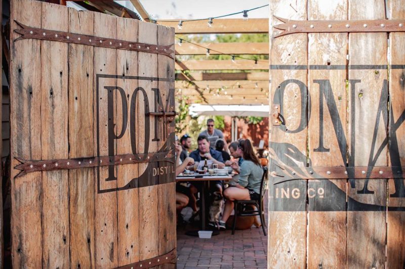 People sat behind the entrance doors to Pomona Distillery 